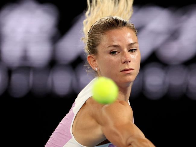 Italy's Camila Giorgi hits a return against Australia's Ashleigh Barty during their women's singles match on day five of the Australian Open tennis tournament in Melbourne on January 21, 2022. (Photo by Martin KEEP / AFP) / -- IMAGE RESTRICTED TO EDITORIAL USE - STRICTLY NO COMMERCIAL USE --