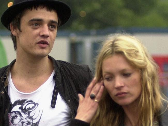 GLASTONBURY, ENGLAND - JUNE 25: Kate Moss and Pete Doherty walk backstage on the second day of the Glastonbury Music Festival 2005 at Worthy Farm, Pilton on June 25, 2005 in Somerset, England. Pete Doherty was at the festival to perform with his band Babyshambles. The festival runs until June 26. (Photo by Matt Cardy/Getty Images)
