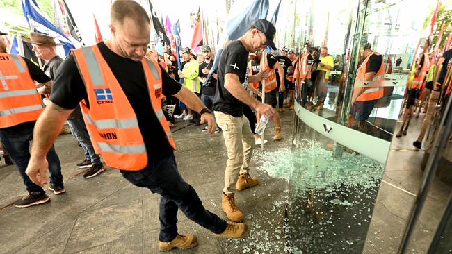 The smashed front door of the federal government offices in Waterfront Place. Picture: Lyndon Mechielsen