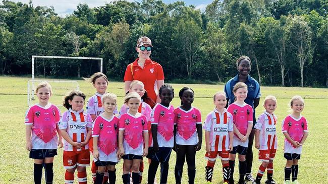 Junior Mackay Wanderers players celebrate Female Football Week.