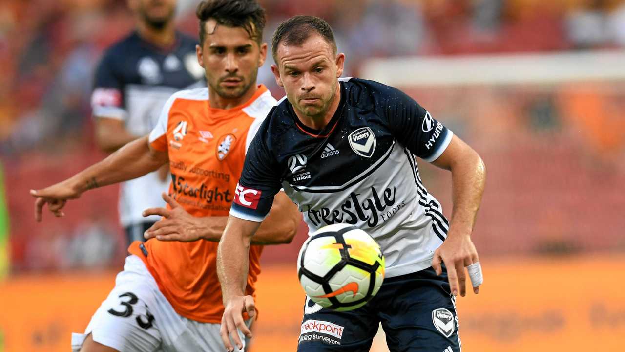 Melbourne Victory's Leigh Broxham (right) gets past his Roar opponent. The Victory will have another derby to look forward to in 2019 with Western Melbourne set the join the A-League. Picture: DAN PELED