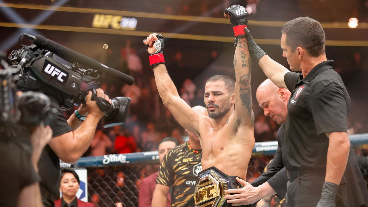 UFC CEO Dana White places a title belt on Alexandre Pantoja of Brazil after Pantoja's win by technical submission in the second round against Kai Asakura of Japan, not pictured, during UFC 310 at T-Mobile Arena on December 07, 2024 in Las Vegas, Nevada. Steve Marcus/Getty Images/AFP (Photo by Steve Marcus / GETTY IMAGES NORTH AMERICA / Getty Images via AFP)