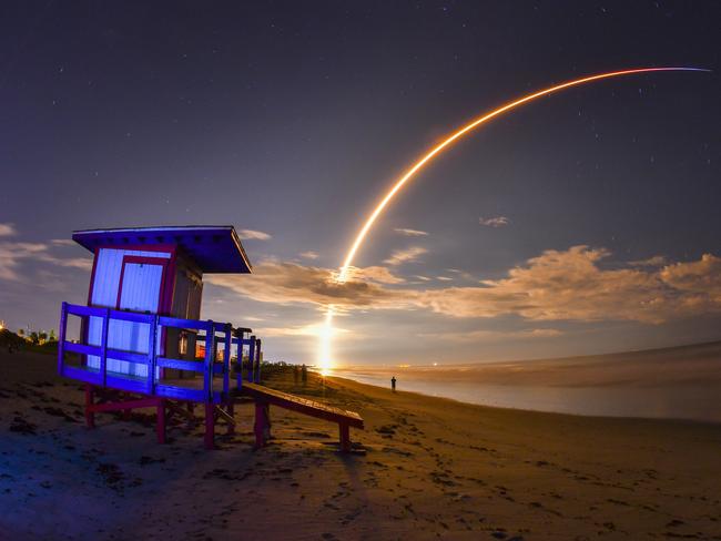 The launch of Telesat's Telstar 18 Vantage communications satellite on a SpaceX Falcon 9 rocket, launched from Launch Complex 40 at Cape Canaveral Air Force Station, is viewed from Minutemen Causeway in Cocoa Beach, early Monday, Sept. 10, 2018. Photo is a 145-second time exposure of the launch with life guard station in the foreground. (Malcolm Denemark/Florida Today via AP)