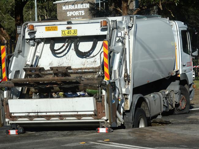 SYDNEY, AUSTRALIA - NewsWire Photos JULY 29. A garbage truck falls into a busted water mains sink hole in Narrabeen ,Wednesday, July 29, 2020. Picture: NCA NewsWire / Jeremy Piper