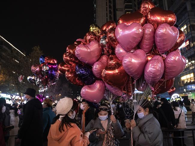 People hold balloons to celebrate the new year on December 31, 2021 in Wuhan, Hubei Province, China. Picture: Getty