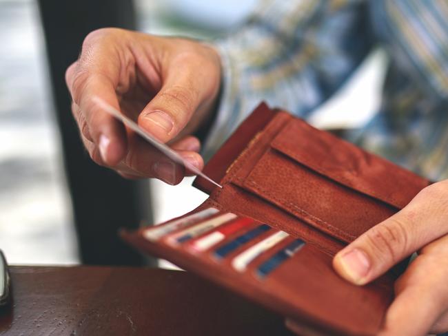 Man buys with a credit card. Generic photo of a wallet, credit cards, paying with credit card. Picture: Mixetto/ Istock