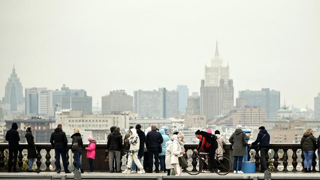 Tourists walk at Vorobyovy Hills observation point in Moscow. Picture: Alexander Nemenov/AFP