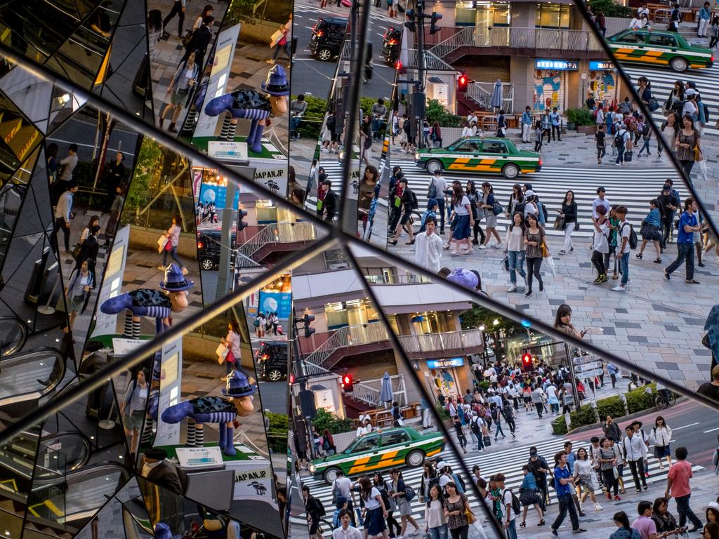 OUR pick of the best photographs from around the world this week ... People are seen reflected in a shopping mall mirror at a busy intersection in the shopping district of Harajuku on June 18, 2015 in Tokyo, Japan. Picture: Getty