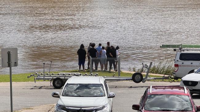 A group of family and friends gather at the pontoon.