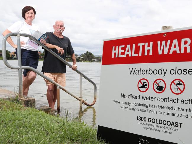 Mermaid Waters residents have been left in a state of confusion with the latest data showing popular swimming lake Hugh Muntz is approaching red alert. GCCC state the waterhole is safe for swimming, contradicting Cr Pauline Young's comments that the lake was never a swimming reserve.  John McManus and division 12 candidate Cathy Osborne check the condition of Luke Hugh Muntz at Robina. Picture Glenn Hampson