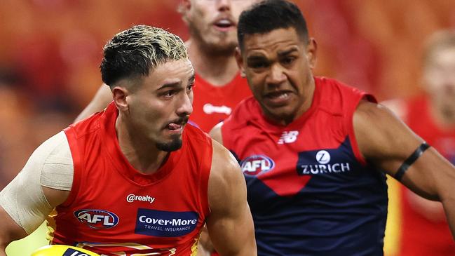 SYDNEY, AUSTRALIA - JULY 11: Izak Rankine of the Suns runs the ball during the round 6 AFL match between the Melbourne Demons and the Gold Coast Suns at GIANTS Stadium on July 11, 2020 in Sydney, Australia. (Photo by Cameron Spencer/Getty Images)