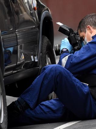 Police study a car outside the building. Picture: Nicole Garmston