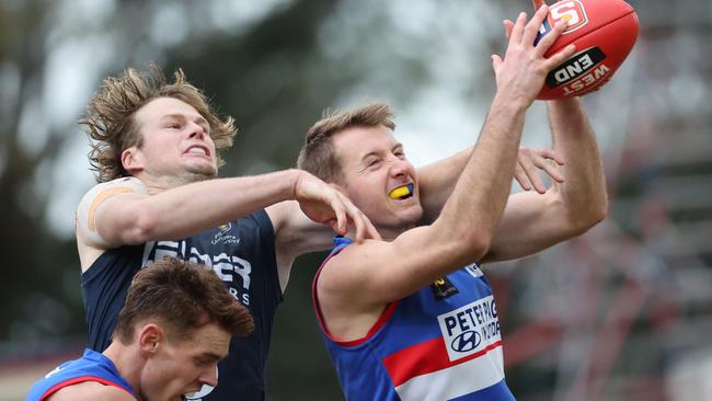 Central District’s George Kendall outmarks South Adelaide’s Damon Freitag at Elizabeth Oval on Saturday. Picture: David Mariuz/SANFL