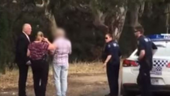 Police question the man at Torrens Park train station.