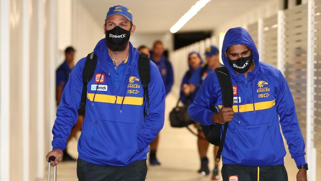 West Coast players arrive at Gold Coast airport with face masks.