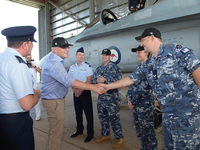 Prime Minister Scott Morrison greets personnel during the official opening of the Joint Strike Fighter building at RAAF base Tindal in Katherine, Northern Territory, Friday, February 21, 2020. (AAP Image/Patrina Malone) NO ARCHIVING