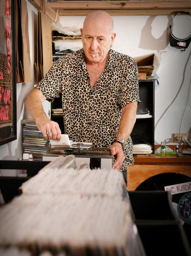 Townsville Records owner Sean Casey searches through his records on offer. He struggles to estimate the amount that he has considering there are many yet to be displayed. Picture: Shae Beplate.