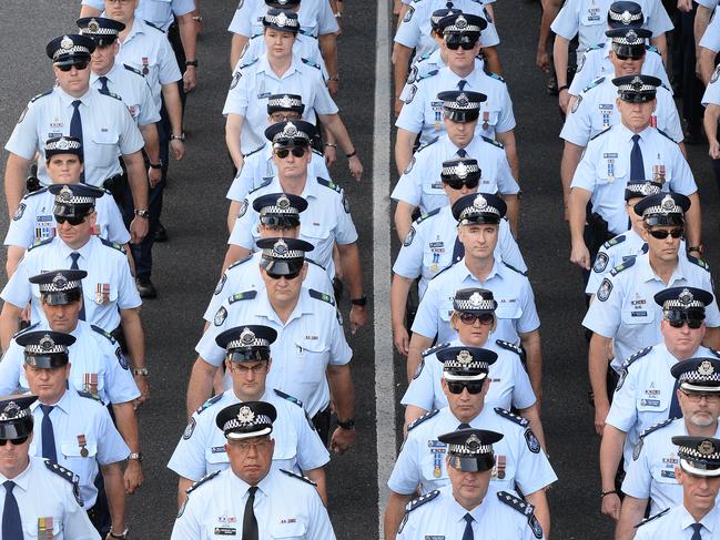 Members of the Queensland Police march in the Brisbane CBD to mark National Police Remembrance Day, Brisbane, Monday, Sept. 29, 2014. (AAP Image/Dave Hunt) NO ARCHIVING