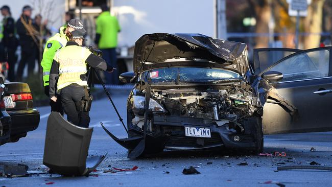 Police investigate a car accident at the scene of a brawl in Mater Street, Collingwood in Melbourne, Sunday, September 2, 2018. (AAP Image/Julian Smith) NO ARCHIVING