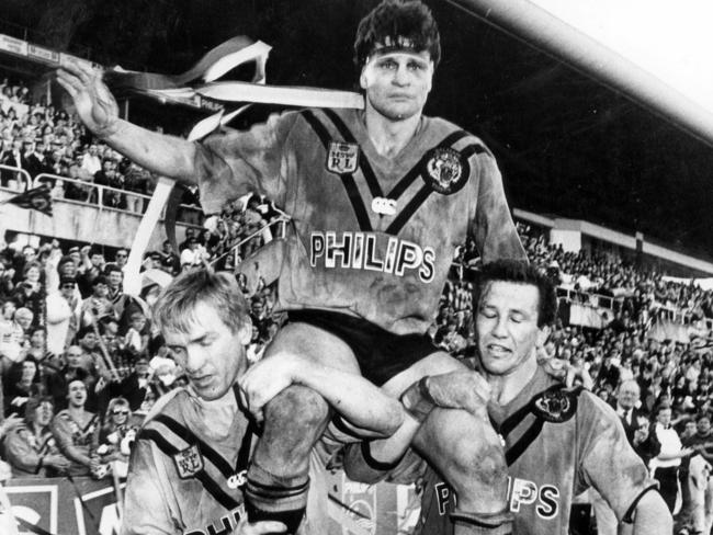 Garry Jack and Bruce McGuire hoist Tigers' player Wayne Pearce on their shoulders during his lap of honour after his final match.