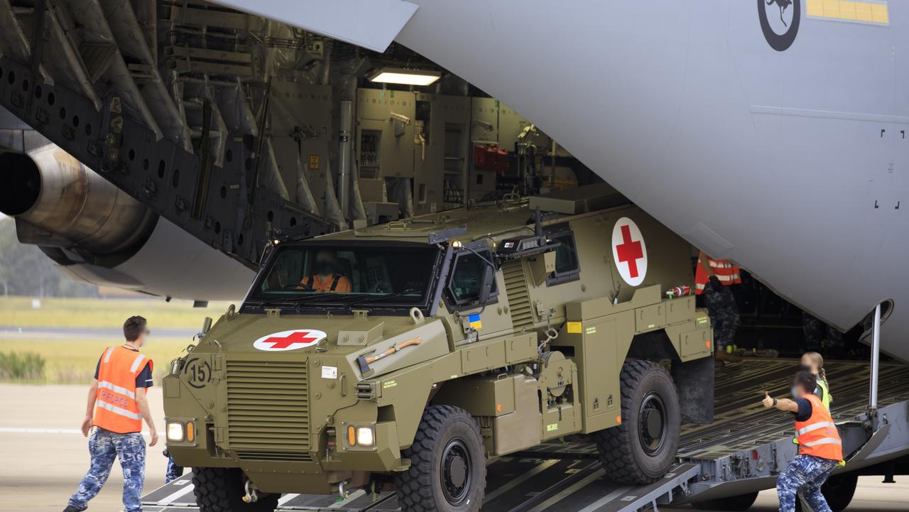 RAAF personnel load a Bushmaster Protected Mobility Vehicle bound for Ukraine on to a C-17A Globemaster III aircraft at RAAF Base Amberley, Queensland.