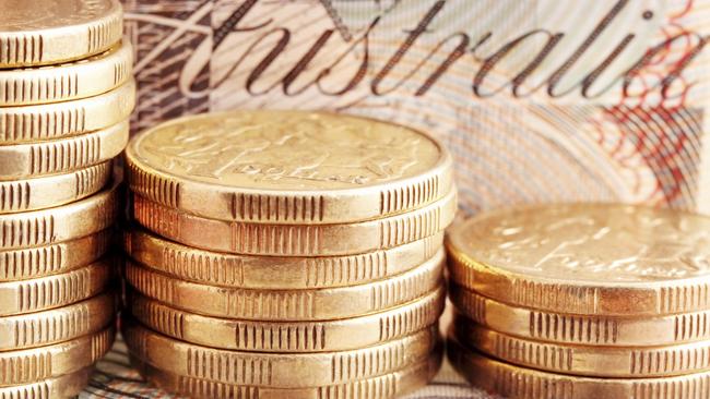 Australian money - coins, cash generic. Stacks of one dollar coins, with twenty dollar note behind.