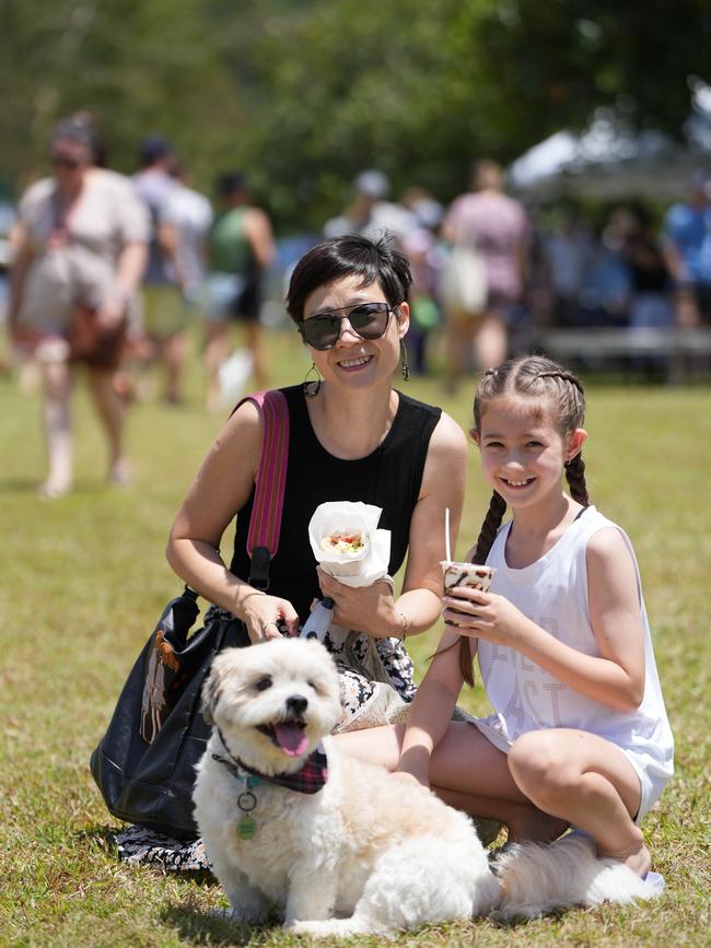 Maggie Zhao and Tia Abbott, 10, and furry friend Coby enjoy the festival at Barron Waters Park. Picture: Nuno Avendano