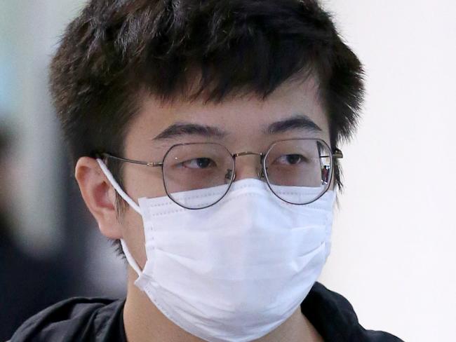 International travellers wearing masks arriving at the Brisbane International Airport arrivals area, Brisbane Thursday 4th March 2020 AAPimage/David Clark