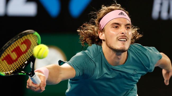 Stefanos Tsitsipas fires a return to Roger Federer during his victory in four sets on Rod Laver Arena last night. Picture: AFP