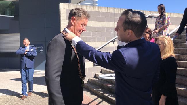 Logan mayor Darren Power wearing the city robes after being sworn in with his 12 councillors at a subdued ceremony at the Logan Entertainment Centre on Tuesday. PHOTO: JUDITH KERR