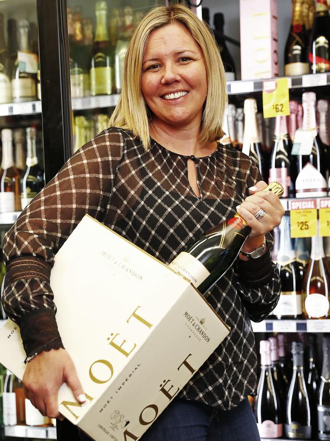 Danielle Richardson, owner of Cellarbrations in Rozelle, pictured filling the champagne fridge where some high end brands are becoming increasingly difficult to buy. Picture: Sam Ruttyn