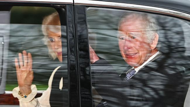 Britain's King Charles III and Britain's Queen Camilla wave as they leave by car from Clarence House in London after meeting with Prince Harry. Picture: AFP