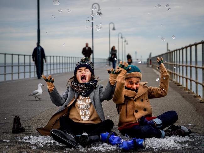 A new winter festival is being launched at Glenelg, Gracie Centenera 8 (dad Paul 0403572500) and George Archontidis 7 get into the spirt with ice and skates on Glenelg Jetty Monday May 31, 2021 - pic Mike Burton