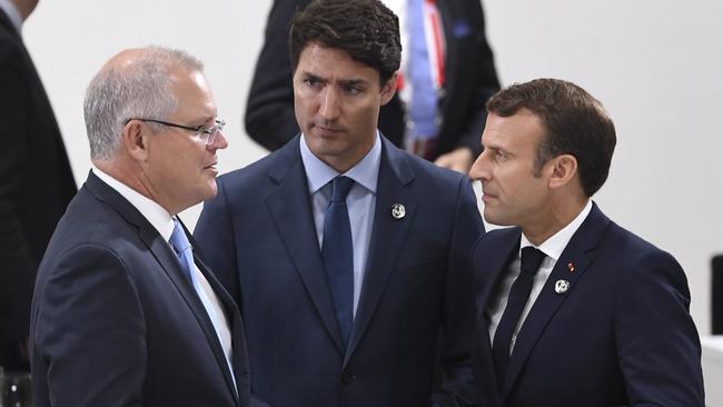 Australian Prime Minister Scott Morrison speaks to Canadian Prime Minister Justin Trudeau (centre) and French President Emmanuel Macron (right) during the G20 summit in Osaka. Picture: AAP