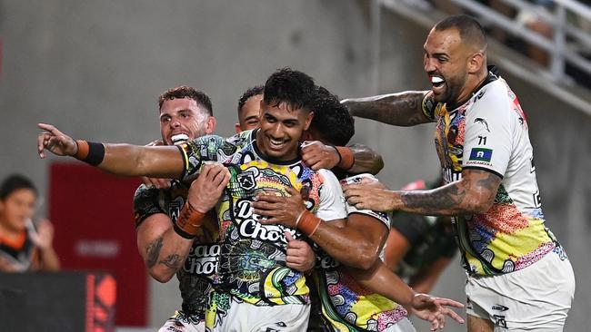 Alofiana Khan-Pereira of the Indigenous All-Stars celebrates with his teammates after scoring a try during the NRL All-Stars match in Townsville. Picture: Ian Hitchcock/Getty Images.