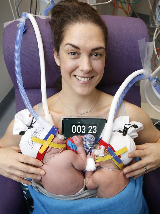 Mother of triplets Paula Savage kangaroo cuddles two of her premature boys, Charlie and Eddie. Picture: David Caird