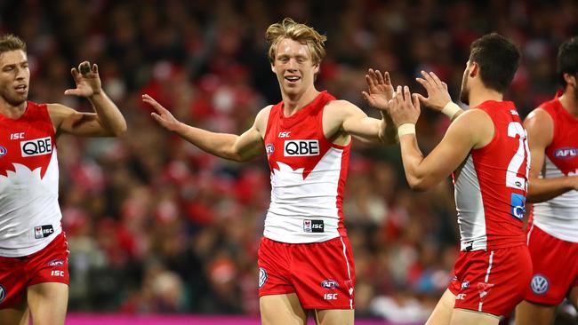 SYDNEY, AUSTRALIA - JULY 22: Callum Mills of the Swans is congratulated by team mates after tackling Blake Acres of the Saints during the round 18 AFL match between the Sydney Swans and the St Kilda Saints at Sydney Cricket Ground on July 22, 2017 in Sydney, Australia. (Photo by Cameron Spencer/AFL Media/Getty Images)