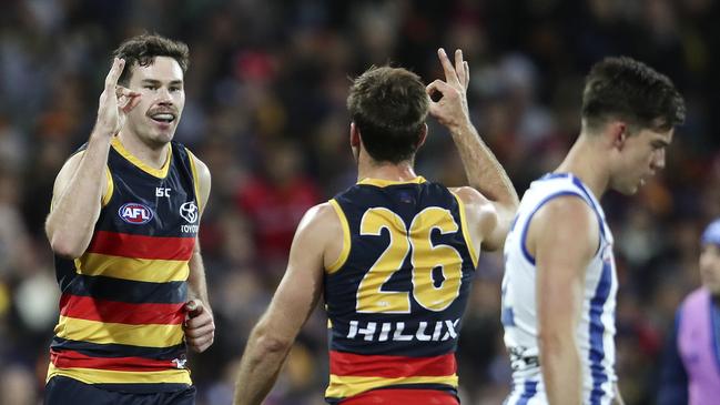 Adelaide’s Mitch McGovern, left, with Richard Douglas after kicking a goal in a 2018 game. Picture: Sarah Reed