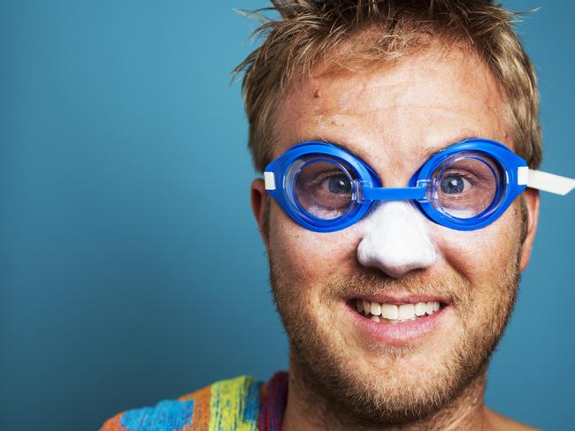 Happy blonde man excited to go swimming