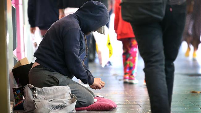 Homeless not Homeless. Police have charged 33 professional and aggressive beggars in a CBD operation during the Australian Open. Police say that most of them have houses in the suburbs and usually drive into town to beg, some with pets to attract sympathy. A possible beggar  on Swanston Street counts his money.    Picture: David Caird