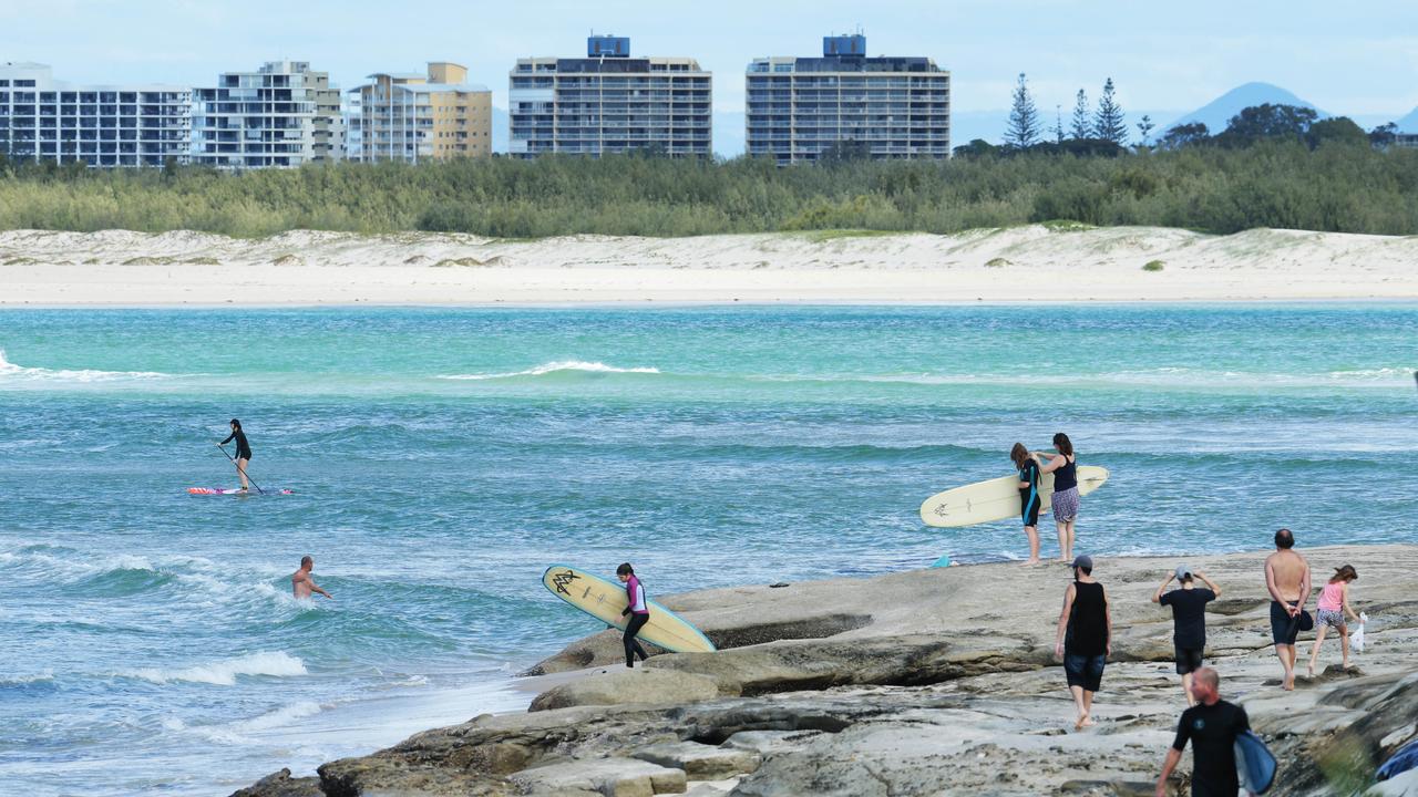 Surfers on the headland at Happy Valley in Caloundra. Photo Lachie Millard