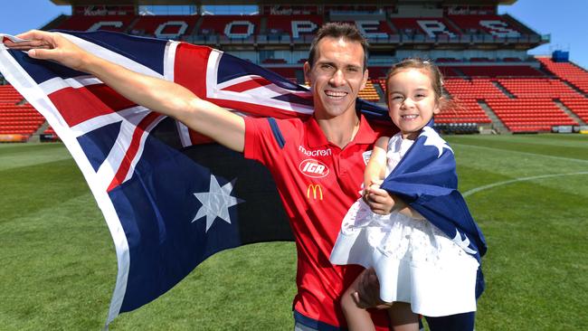 Adelaide United captain Isaias celebrates his Australian citizenship with daughter Vega, three, at Hindmarsh Stadium. Picture: AAP Image/ Brenton Edwards