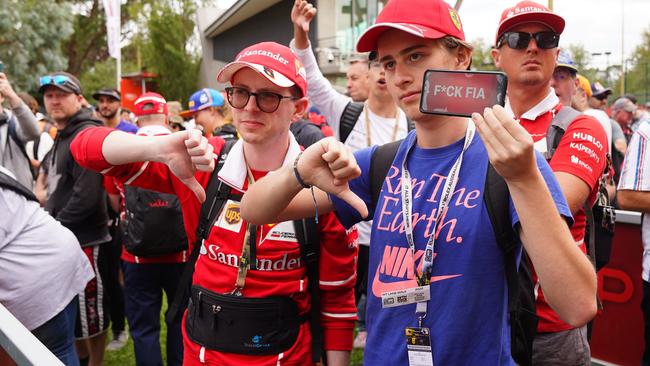 Spectators react after it was announced that the Formula 1 Australian Grand Prix was cancelled at the Albert Park Circuit in Melbourne Picture: AAP