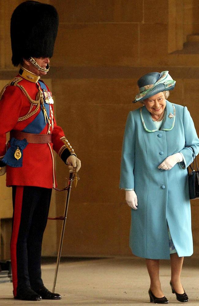 The Queen walks past Prince Philip at Buckingham Palace in 2005. Picture: by Anwar Hussein/Getty Images