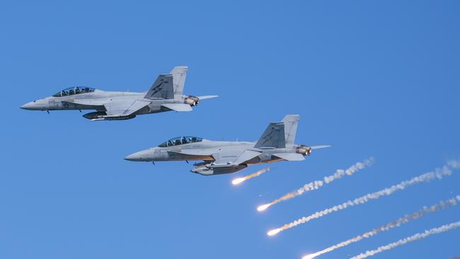 An Air Force F/A-18F Super Hornet and EA-18G Growler fly in formation during a handling display at Nobby's Beach, as part of the Newcastle Williamtown Air Show 2023.