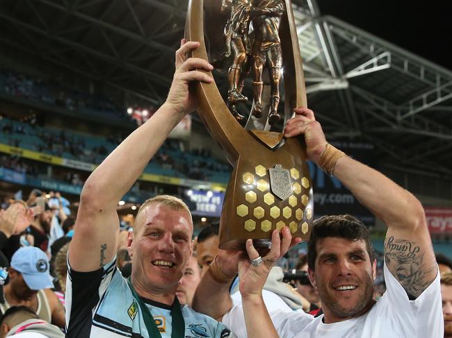 Michael Ennis and Luke Lewis of the Sharks hold the trophy after the NRL Grand Final between the Melbourne Storm and the Cronulla-Sutherland Sharks at ANZ Stadium in Sydney, Sunday, Oct. 2, 2016. (AAP Image/Craig Golding) NO ARCHIVING, EDITORIAL USE ONLY