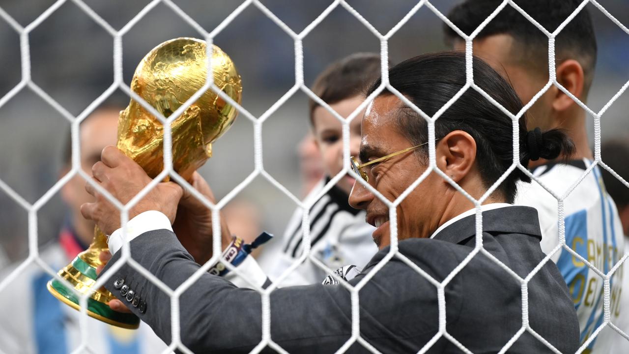 Nusret Goekce, nicknamed Salt Bae, admires the FIFA World Cup winner’s trophy. Picture: Getty Images