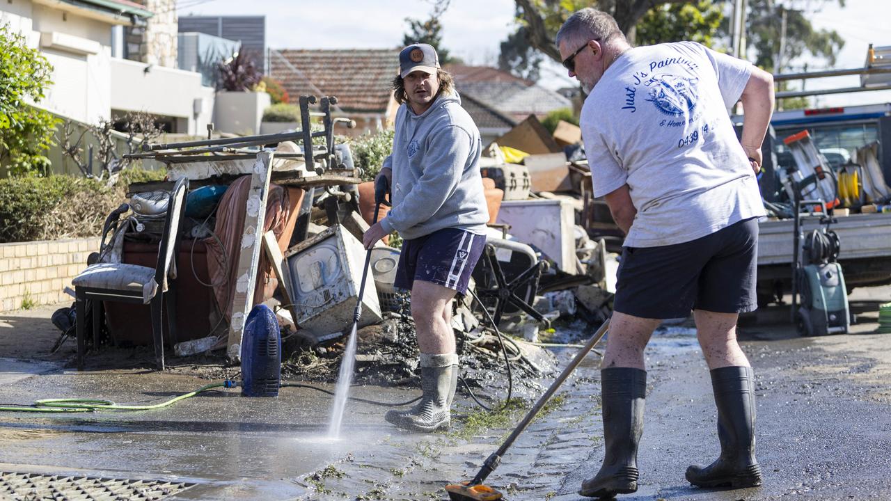 Residents of Clyde Street Maribyrnong begin the clean up. Picture: Aaron Francis