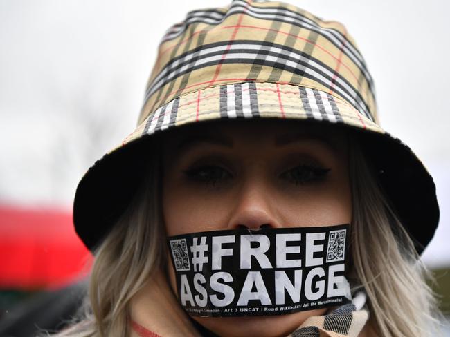 A supporter of WikiLeaks founder Julian Assange wearing tape on her mouth outside Woolwich Crown Court. Picture: AFP