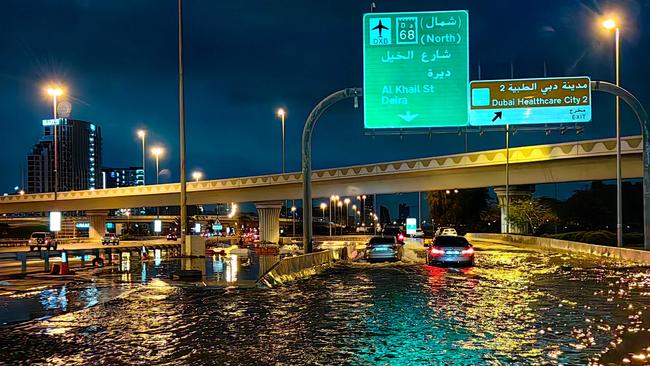 Motorists drive along a flooded street following heavy rains in Dubai early on Wednesday, April 17, 2024. Picture: Giuseppe Cacace / AFP